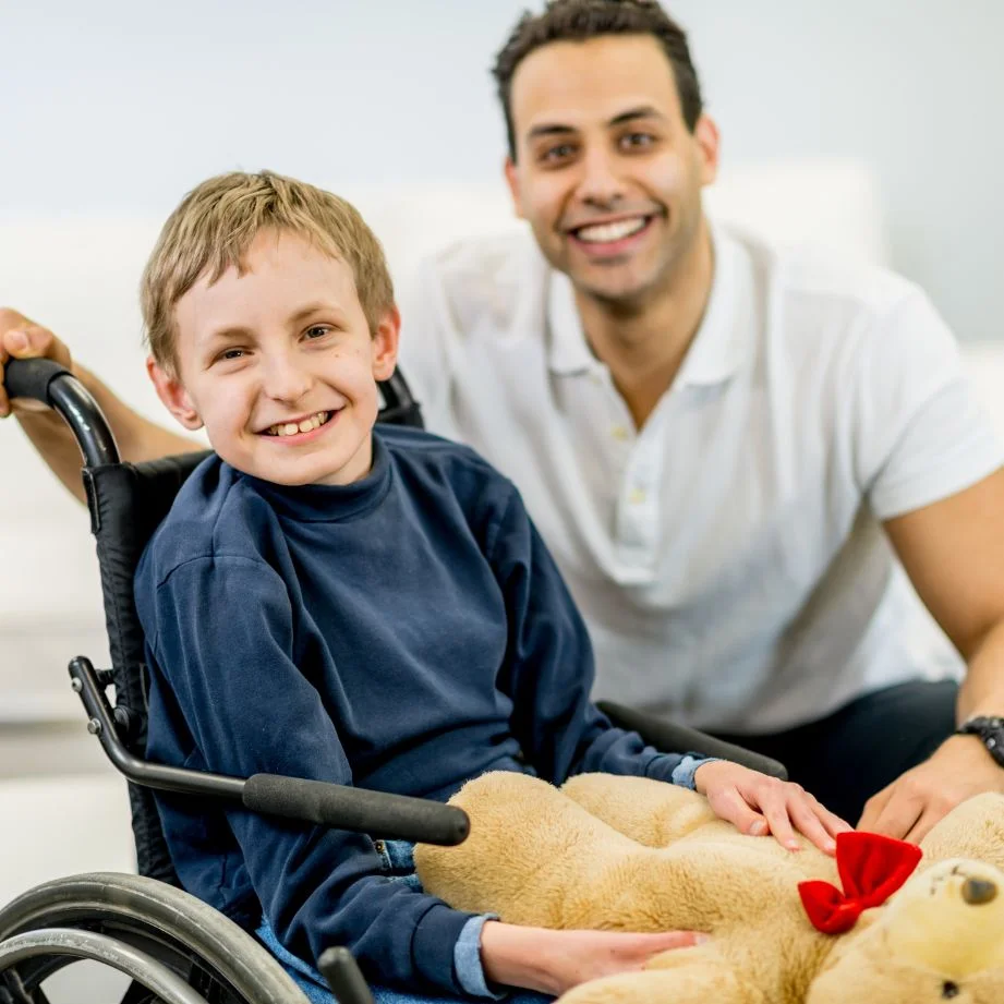 Serenity_Village_Events_Page_Disable_Kid_With_Young_Man_Smiling