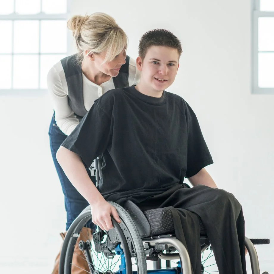 Serenity_Village_Public_Policy_Page_Kid_On_Wheel_Chair_With_Lady